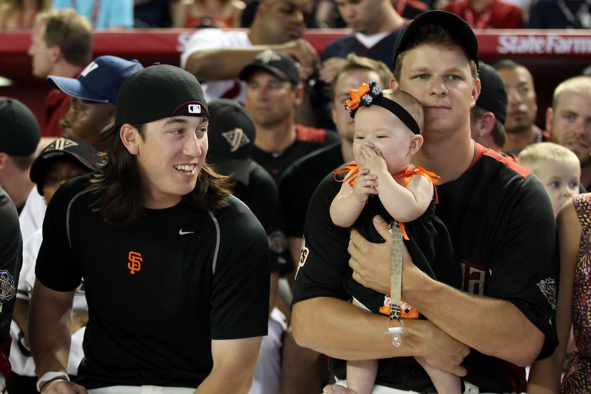 Tim Lincecum, Matt Cain, and Matt Cain’s daughter Hartley watching the 2011 Home Run Derby