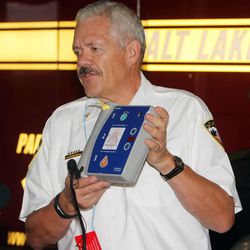 Clair Baldwin, chief of Salt Lake City Fire Departments Division of Medical Services, describes how to operate an automatic external defibrillator at Station No. 11 in Salt Lake City, Monday, Aug. 4, 2014, as University of Utah Health Care and Salt Lake City Fire Department announce a scavenger hunt, asking the public's help in locating all defibrillators in the city.