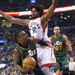 Toronto Raptors center Lucas Nogueira (92) defends against Utah Jazz guard Shelvin Mack (8) during the first half of an NBA basketball game, Wednesday, March 2, 2016 in Toronto. (Nathan Denette/The Canadian Press via AP) MANDATORY CREDIT