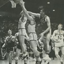Players from LDS wards in Arizona and Salt Lake go after the ball in the 1965 All-Church basketball tournament. 