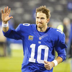 Eli Manning waves to the crowd as he leaves the field Monday  