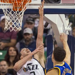 Utah forward Joe Ingles (2) scores a layup past Golden State guard Klay Thompson (11) during the second half of an NBA basketball game in Salt Lake City on Thursday, Dec. 8, 2016. Golden State defeated Utah with a final score of 106-99.