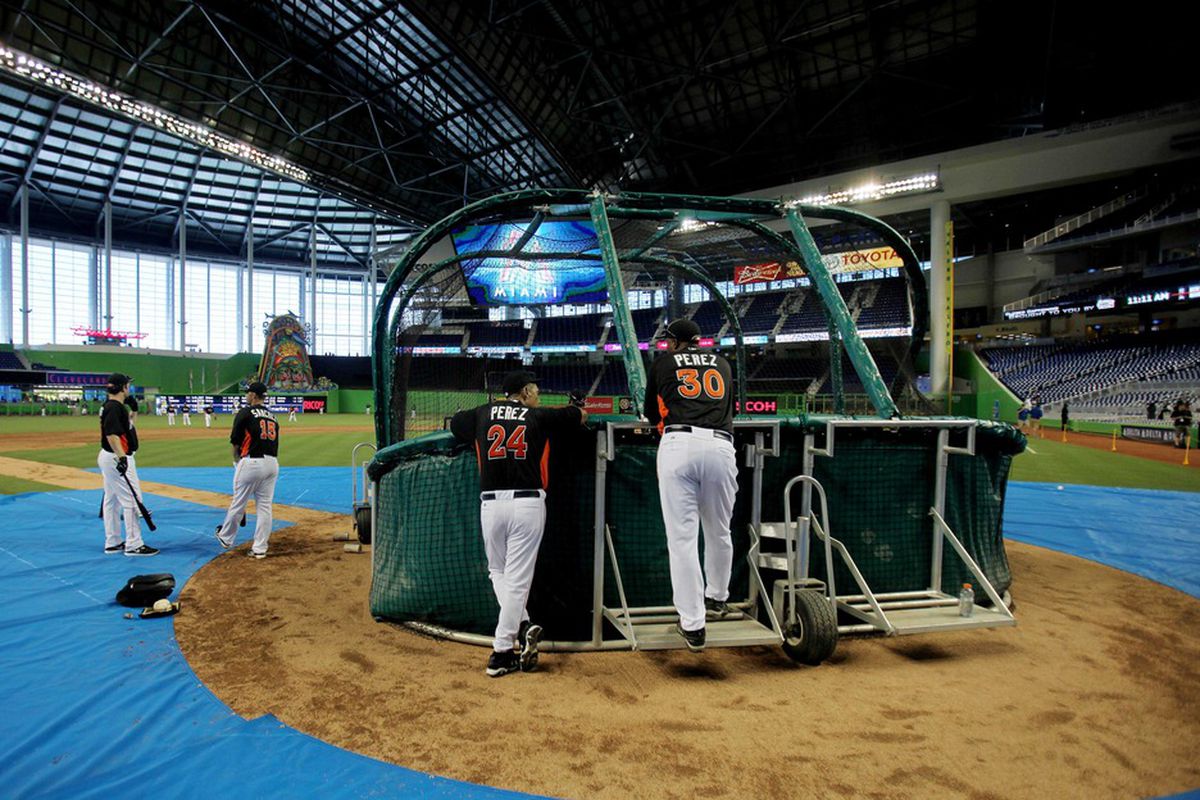 April 1, 2012; Miami, FL, USA;  Miami Marlins batting coach Eduardo Perez (30) and his father Tony Perez (24) watch batting practice before a game against the New York Yankees at Marlins Park. Mandatory Credit: Robert Mayer-US PRESSWIRE