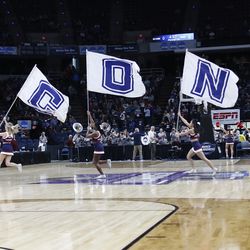 The UConn cheerleaders lead the team onto the court.