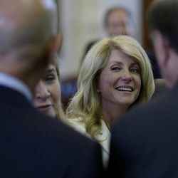 Sen. Wendy Davis, D-Fort Worth, center, talks with fellow senators during a recess, Monday, June 24, 2013, in Austin, Texas. Senate democrats are trying to hold off on a  bill that  would ban abortion after 20 weeks of pregnancy and force many clinics that perform the procedure to upgrade their facilities and be classified as ambulatory surgical centers.  (AP Photo/Eric Gay)