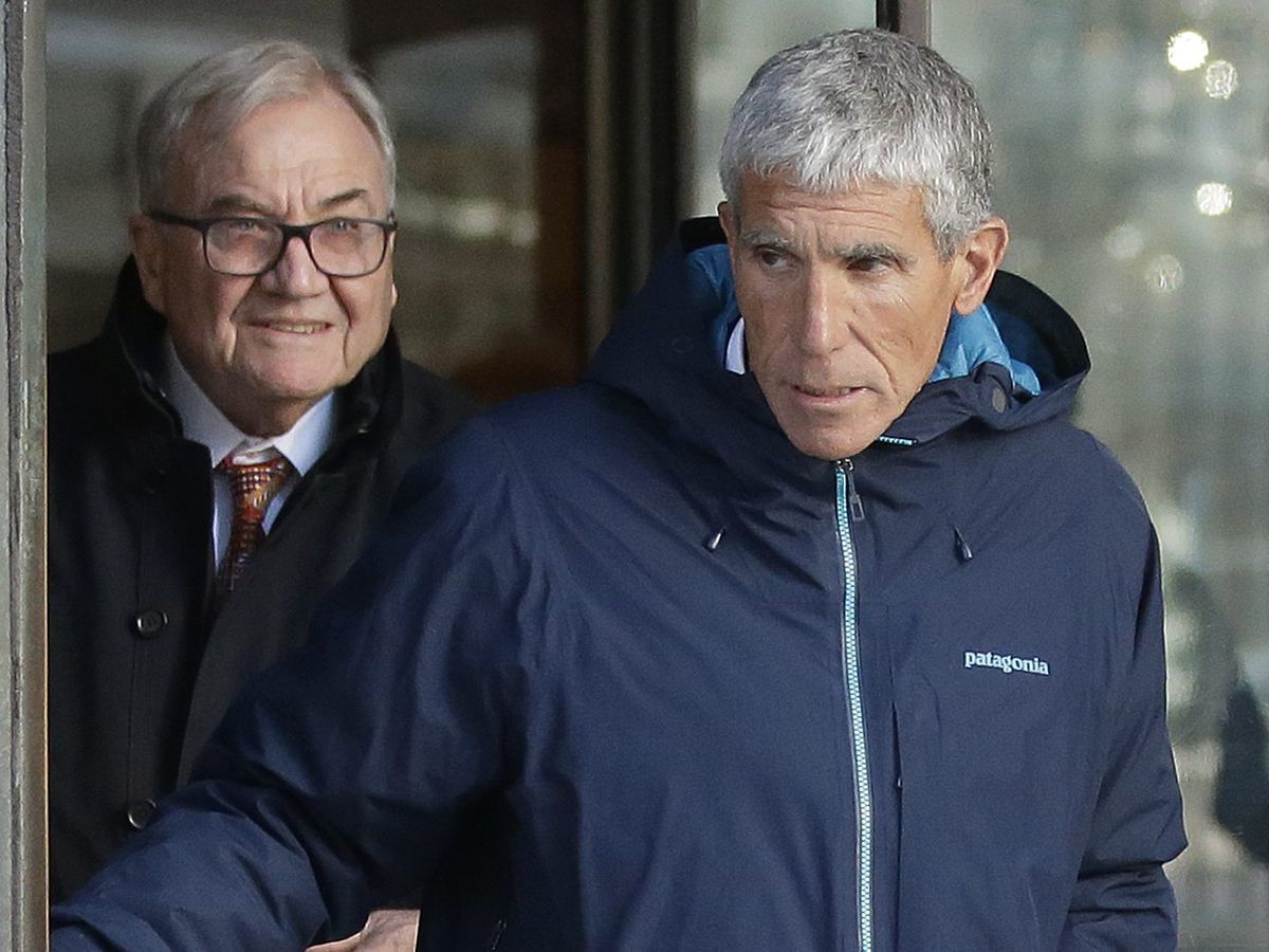 William “Rick” Singer, front, founder of the Edge College &amp; Career Network, exits federal court in Boston on Tuesday, March 12, 2019, after he pleaded guilty to charges in a nationwide college admissions bribery scandal. (AP Photo/Steven Senne)