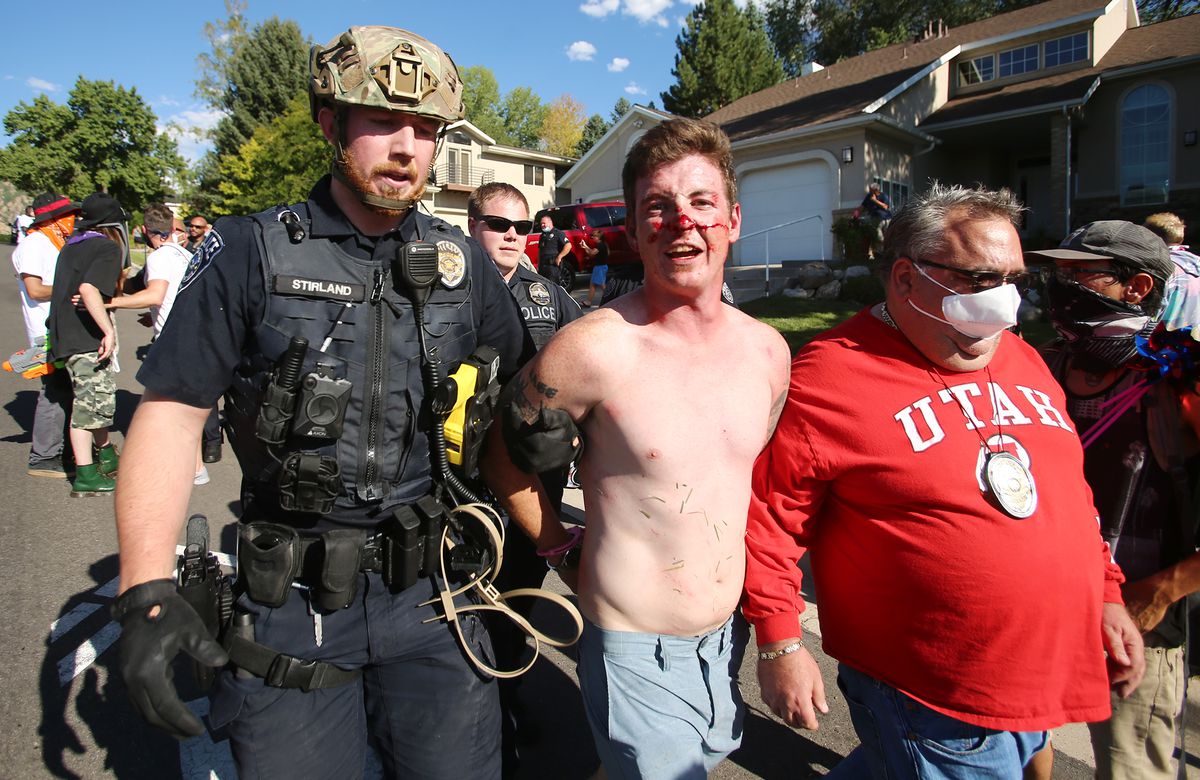 Gabriel Pecoraro is taken into custody after police and marchers collided in the streets of Cottonwood Heights on Sunday, Aug. 2, 2020. The group was marching on 6710 South when police blocked them at Cristobal Street and a confrontation ensued. Police said eight or nine protesters were arrested.