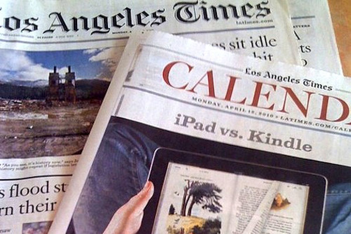 An overhead shot of the LA Times newspaper showing old headlines and the Calendar section.