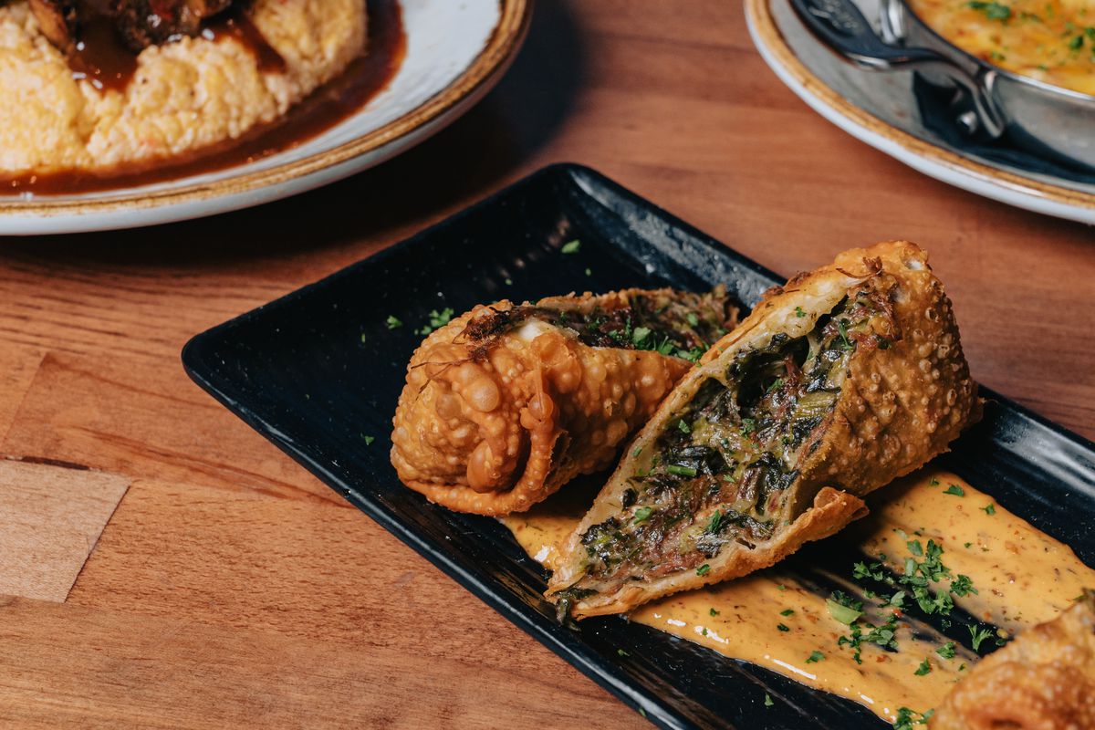 Oxtail egg rolls served over a creamy sauce at Rockhouse Southern Kitchen.