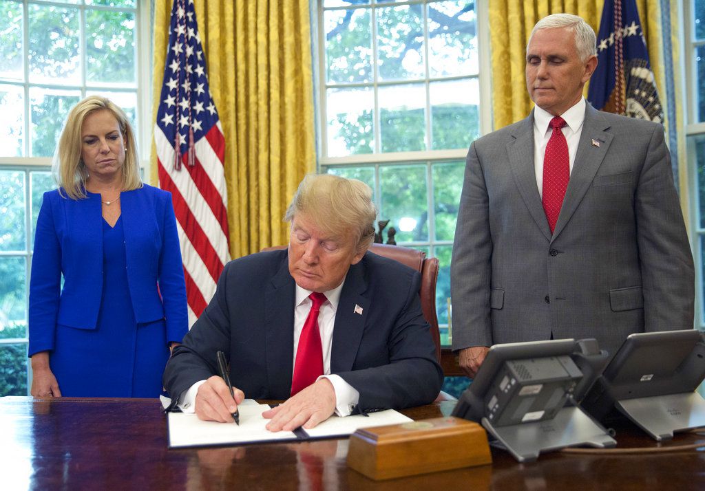 President Donald Trump signs an executive order to keep families together at the border, but says that the ‘zero-tolerance’ prosecution policy will continue, during an event in the Oval Office of the White House in Washington, Wednesday, June 20, 2018. | 