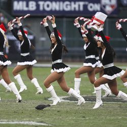 Dec 16, 2012; Oakland, CA, USA; Oakland Raiders cheerleader perform with a pigeon at their feet during half time against the Kansas City Chiefs at O.co Coliseum.