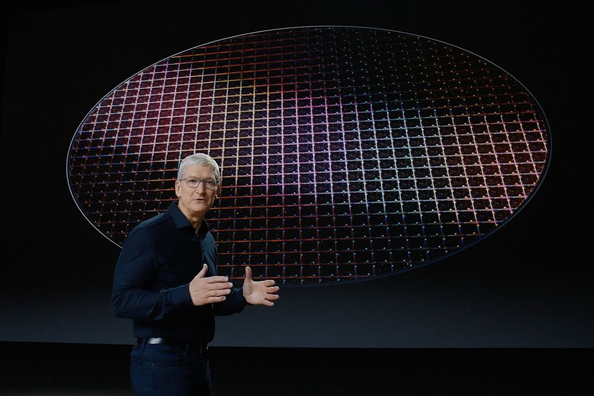 Apple CEO Tim Cook in front of a silicon wafer platter