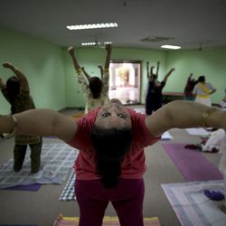 In this Thursday, June 18, 2015, photo, Indians perform yoga at the Morarji Desai National Institute of Yoga, in New Delhi, India. There are no reliable estimates of how many people regularly practice yoga in India, though the number is certainly in the millions. Sunday, June 21, 2015, marks the first International Yoga Day, which the government of Prime Minister Narendra Modi is marking with a massive outdoor New Delhi gathering. 