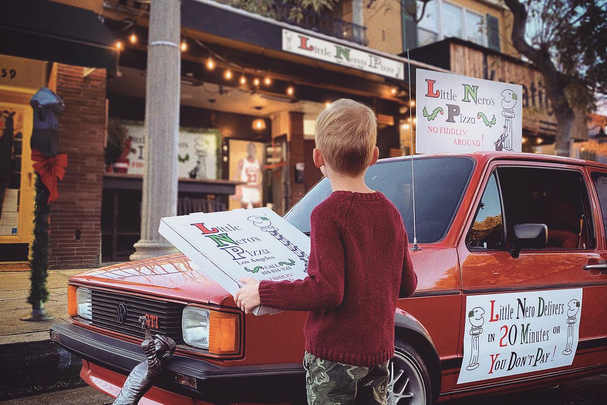 A pop culture food pop up featuring a red car and branded pizza boxes.
