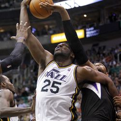 Al Jefferson, of Utah, is fouled by DeMarcus Cousins of Sacramento, right, as the Sacramento Kings face the Utah Jazz in NBA basketball in Salt Lake City, Friday, March 30, 2012.