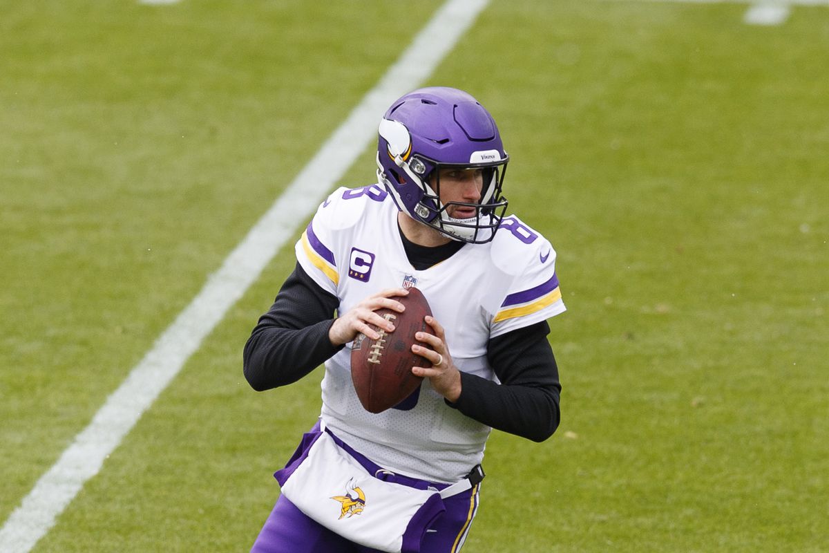 Minnesota Vikings quarterback Kirk Cousins (8) rolls out to throw a pass against the Green Bay Packers during the first quarter at Lambeau Field.&nbsp;