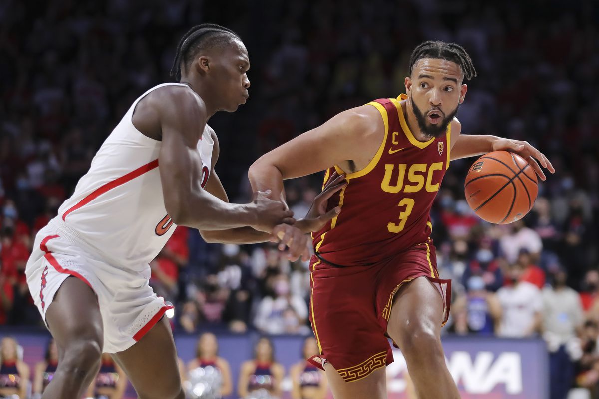 Forward Isaiah Mobley of the USC Trojans looks for a route past guard Bennedict Mathurin of the Arizona Wildcats at McKale Center on February 05, 2022 in Tucson, Arizona. 