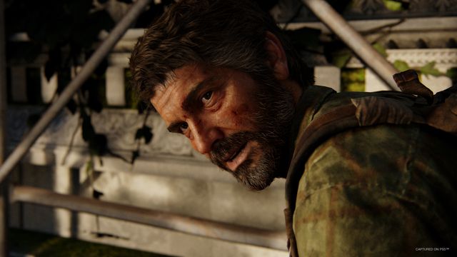 Joel leans over in a still from The Last of Us Part 1, captured on PS5