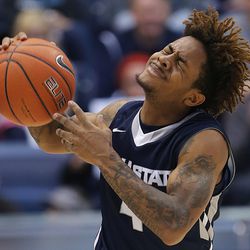Utah State Aggies guard Shane Rector (4) reacts after being called for a foul on Brigham Young Cougars guard Kyle Collinsworth (5) as BYU and Utah State play at the Marriott Center in Provo Wednesday, Dec. 9, 2015.