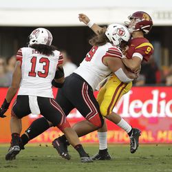 Southern California quarterback Kedon Slovis (9) is hit by by Utah defensive tackle Leki Fotu during the first half of an NCAA college football game Friday, Sept. 20, 2019, in Los Angeles. 