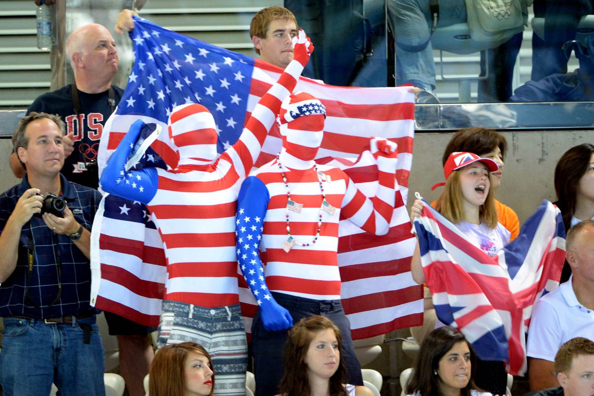 Jul 31, 2012; London, United Kingdom; Fans of the United States and Great Britain wave flags during a mens 4 x 200m freestyle relay heat during the London 2012 Olympic Games at Aquatics Centre. Mandatory Credit: Kirby Lee-USA TODAY Sports