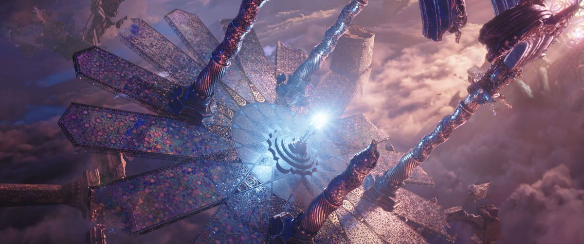 A pink-and-purple CGI vista seen through a Dutch tilt, showing a glowing blue-white light on a plinth surrounded by narrow, twisted minarets in Doctor Strange in the Multiverse of Madness.