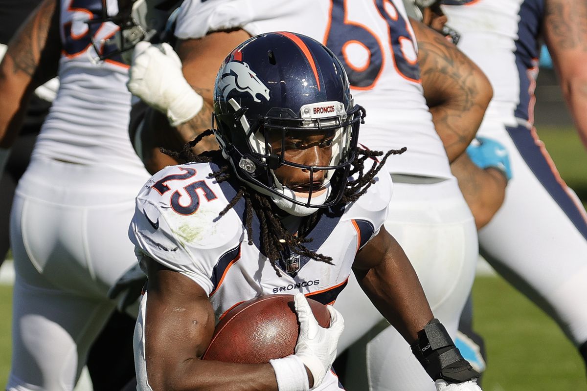 Melvin Gordon III of the Denver Broncos carries the ball during the first quarter of their game against the Carolina Panthers at Bank of America Stadium on December 13, 2020 in Charlotte, North Carolina.