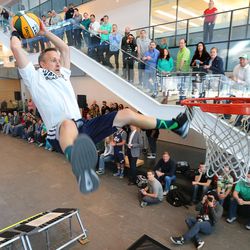 Utah Jazz Dunk Team member Nate Felt slams home a dunk as the team performs for employees of NuSkin in Provo Thursday, March 17, 2016.