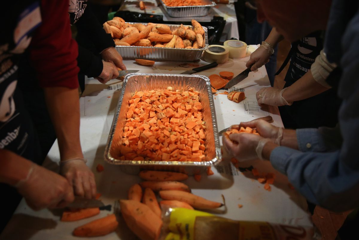 Volunteers Prepare Thanksgiving Meals For The Needy