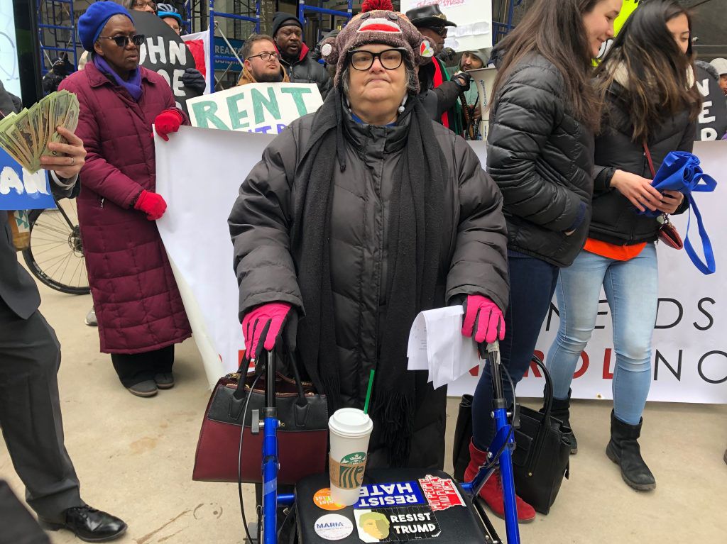 Debra Miller stands with a coalition of organizers rallying in support of lifting the ban on rent control. | Sun-Times/Alex Arriaga