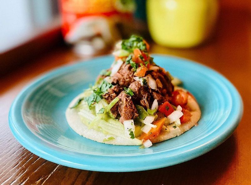 A taco on a light-blue plate.
