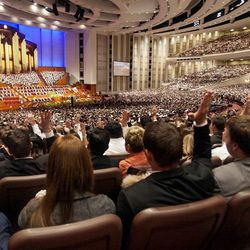 Members of the audience take part in the sustaining vote during the afternoon session Saturday, April 6, 2013 of the 183th Annual General Conference of The Church of Jesus Christ of Latter-day Saints in the Conference Center.