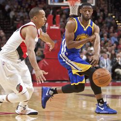 Golden State Warriors guard Ian Clark, right, passes around Portland Trail Blazers guard C.J. McCollum, left, during the first half of an NBA basketball game in Portland, Ore., Tuesday, Nov. 1, 2016. (AP Photo/Craig Mitchelldyer)