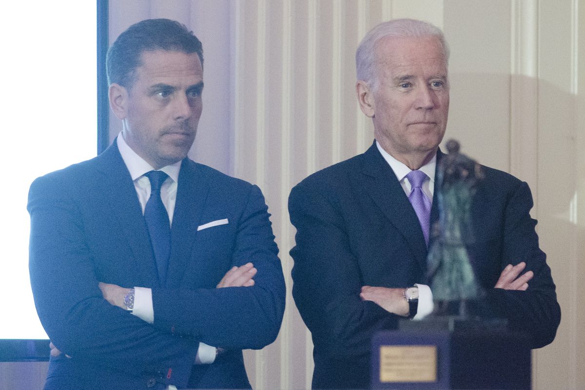 Hunter Biden and Joe Biden stand next to each other, both with arms crossed.
