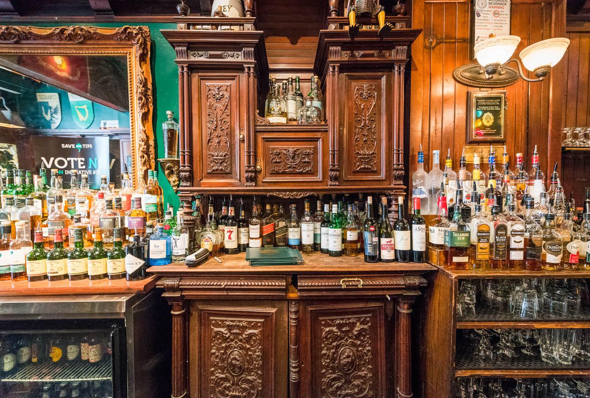 A mahogany bar decorated with bottles