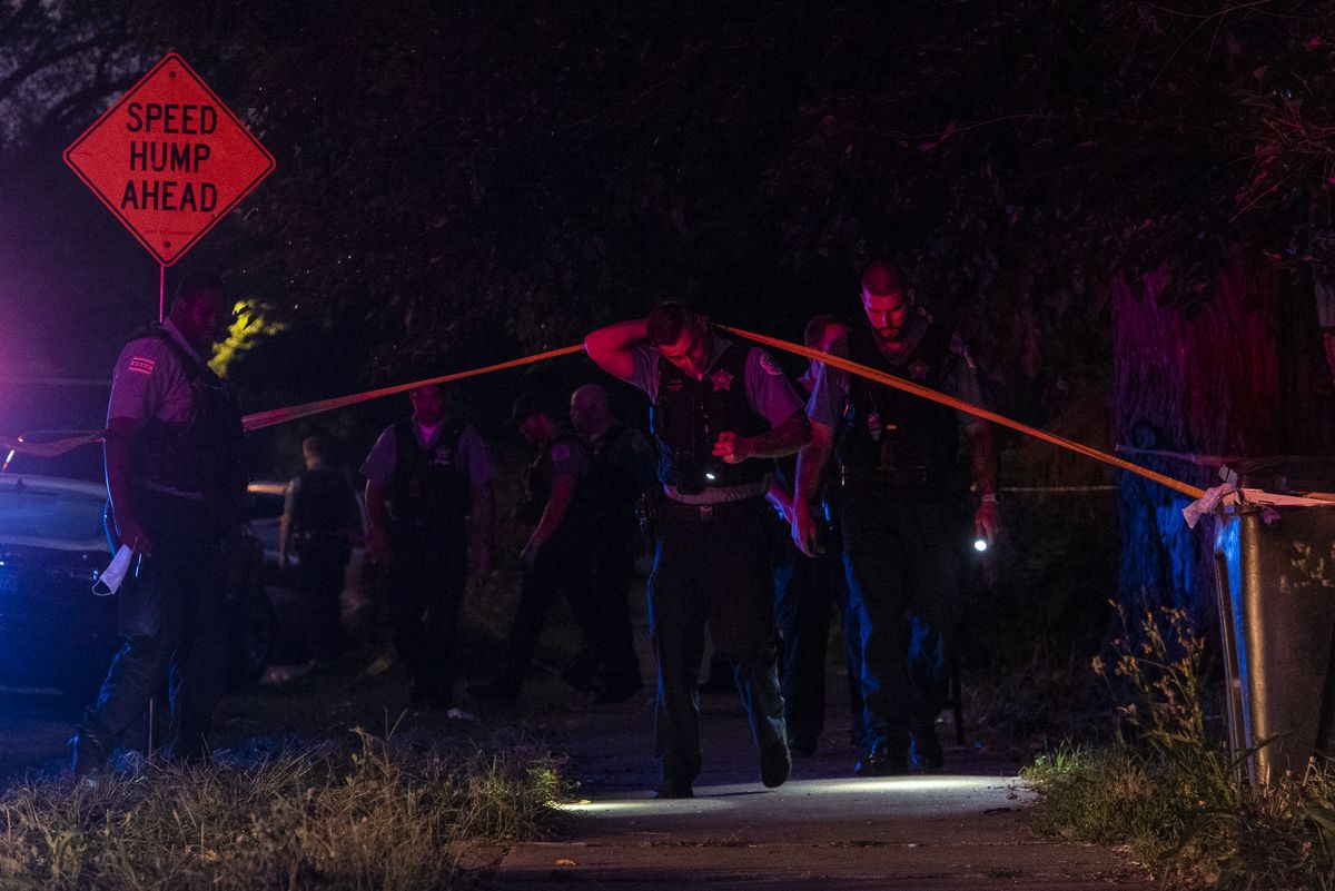 Chicago police investigate the scene where two people were shot, in the 900 block of West 50th Street, in the Back of the Yards neighborhood. | Tyler LaRiviere/Sun-Times