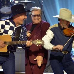 FILE - In this Nov. 7, 2001 file photo, Garth Brooks, left, and George Jones, center, perform their duet "Beer Run" at the Country Music Association Awards show in Nashville, Tenn.   The fiddle player at right is unidentified.   Jones, the peerless, hard-living country singer who recorded dozens of hits about good times and regrets and peaked with the heartbreaking classic "He Stopped Loving Her Today," has died. He was 81. Jones died Friday, April 26, 2013 at Vanderbilt University Medical Center in Nashville after being hospitalized with fever and irregular blood pressure, according to his publicist Kirt Webster.