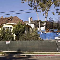 This Wednesday, Jan. 14, 2015, photo, shows a house being demolished that science fiction writer Ray Bradbury lived in, in the Cheviot Hills neighborhood of Los Angeles. It was the house where Bradbury wrote "Something Wicked This Way Comes," and when the bulldozer came to knock it down literary scholars and preservationists were aghast. The bright yellow home with the big bay windows where the author lived and worked for 54 years wasn't the first Los Angeles landmark to be flattened of course. The statuesque Ambassador Hotel, where Robert Kennedy was assassinated in 1968, is now the site of a public-school complex. 