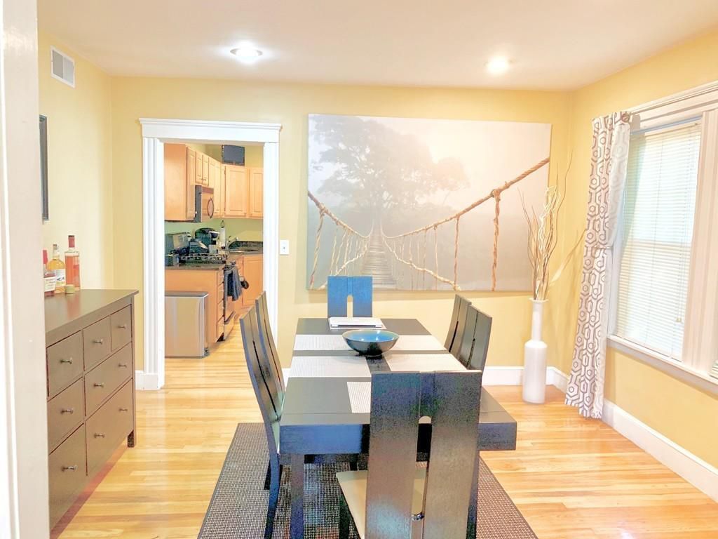 A dining room with a narrow table and chairs.