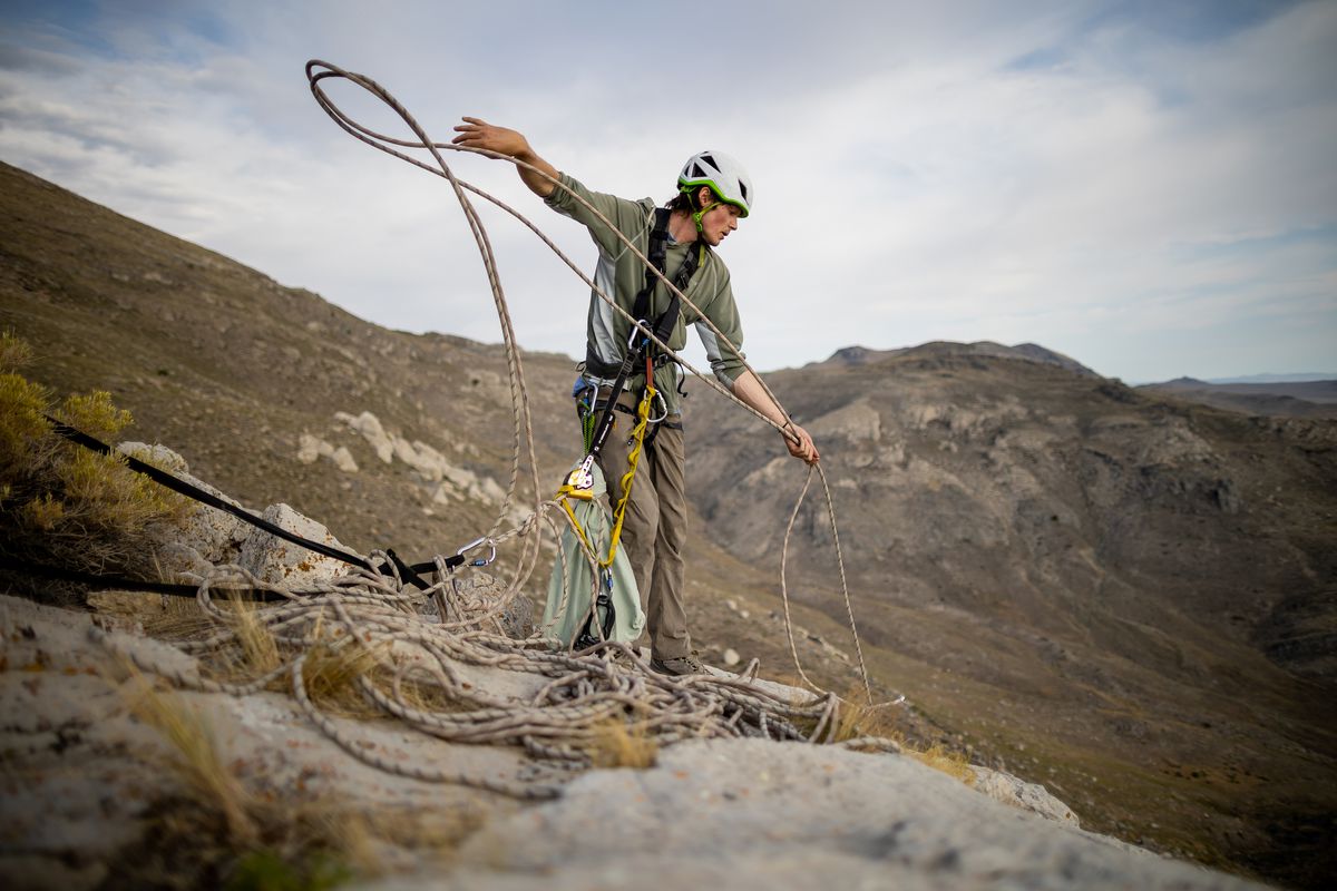 Hawkwatch International research associate Dustin Maloney pulls up his rigging after finding two golden eagle nestlings were dead in their nest in Tooele County on Friday, June 18, 2021.