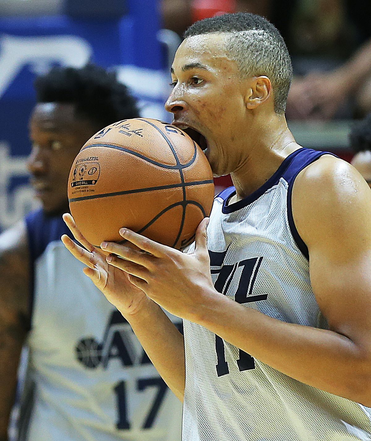 Utah Jazz guard Dante Exum (11) looks to eat the ball after a play as the Utah Jazz and the Philadelphia 76ers play in summer league action in the Huntsman Center at the University of Utah in Salt Lake City on Wednesday, July 5, 2017.