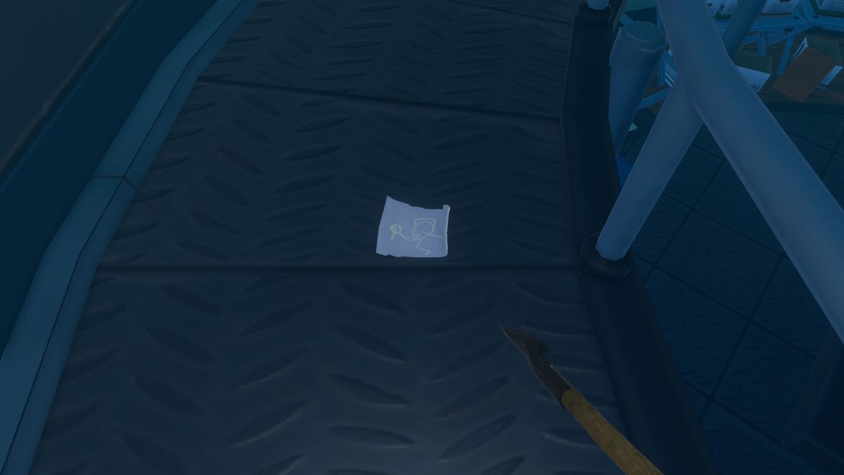 A blue sticky note with a bird drawn on it sits on the floor