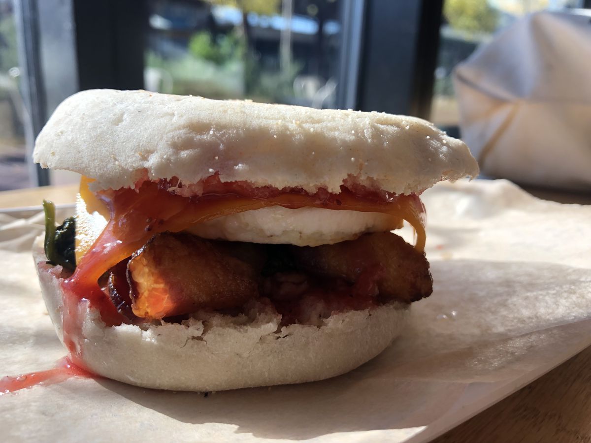 Dudley Cafe’s Roxbury Deluxe, a breakfast sandwich with egg, bacon, and fruit jam on an english muffin.