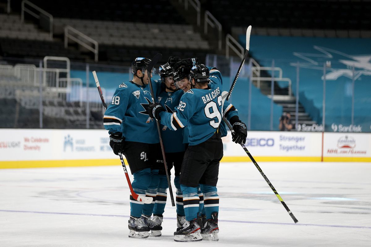 Nikolai Knyzhov #71 of the San Jose Sharks is congratulated by teammates after he scored a goal against the Minnesota Wild in the third period at SAP Center on March 31, 2021 in San Jose, California.