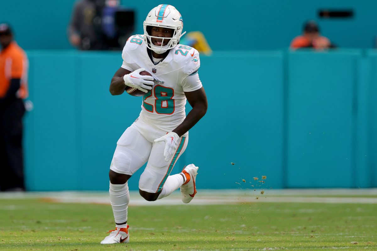 De’Von Achane #28 of the Miami Dolphins carries the ball against the Las Vegas Raiders during the first half of the game at Hard Rock Stadium on November 19, 2023 in Miami Gardens, Florida.