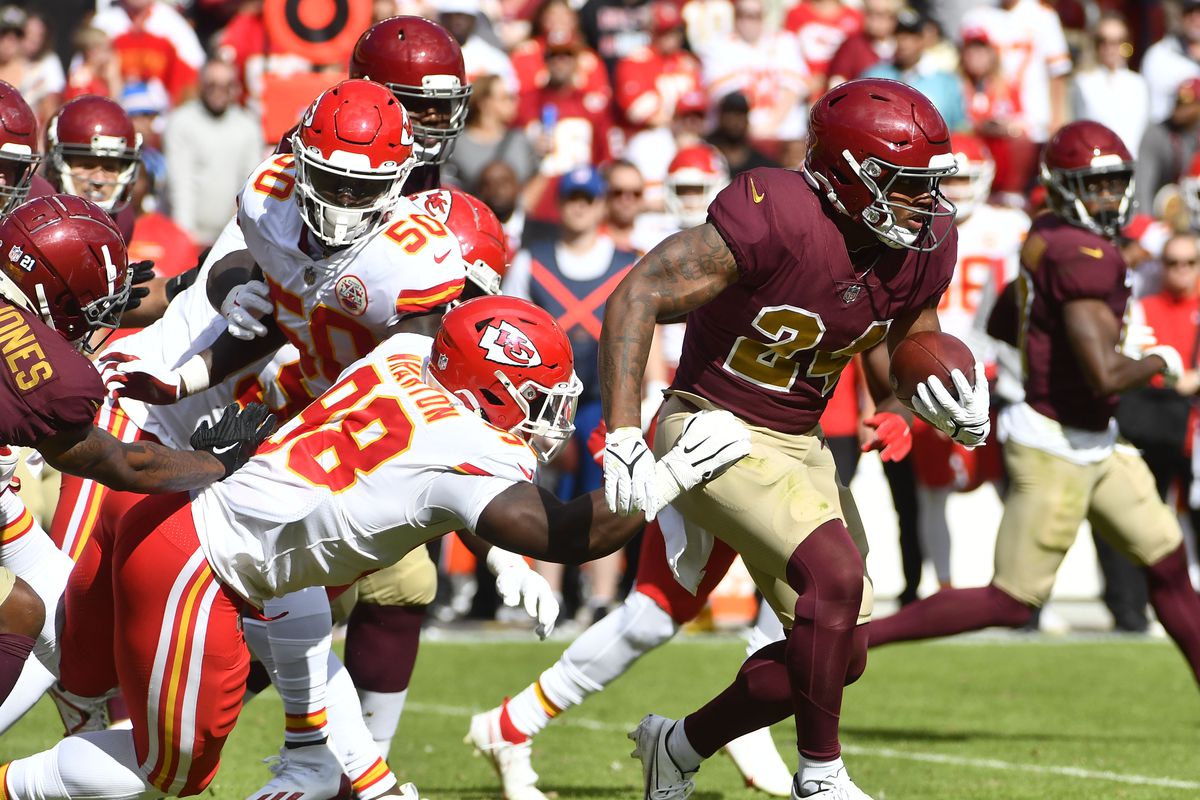 Washington Football Team running back Antonio Gibson (24) is tackled by Kansas City Chiefs defensive end Tershawn Wharton (98) during the first half at FedExField.