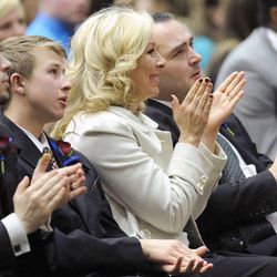 Nanette Wride along with her sons, from left, Shea Wride, Tyesun Wride and Nathan Mohler applaud the news that Utah County sheriff's deputy Greg Sherwood had surgery earlier in the day to remove the remnants of his gunshot wound during the funeral service for her late husband, Utah County Sheriff's Sgt. Cory Wride, at the UCCU Center in Orem on Wednesday, Feb. 5, 2014.