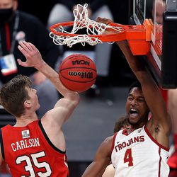 USC Trojans forward Evan Mobley (4) dunks the ball from behind Utah Utes center Branden Carlson (35) as Utah and USC play in the Pac-12 Tournament at T-Mobile Arena in Las Vegas on Thursday, March 11, 2021.