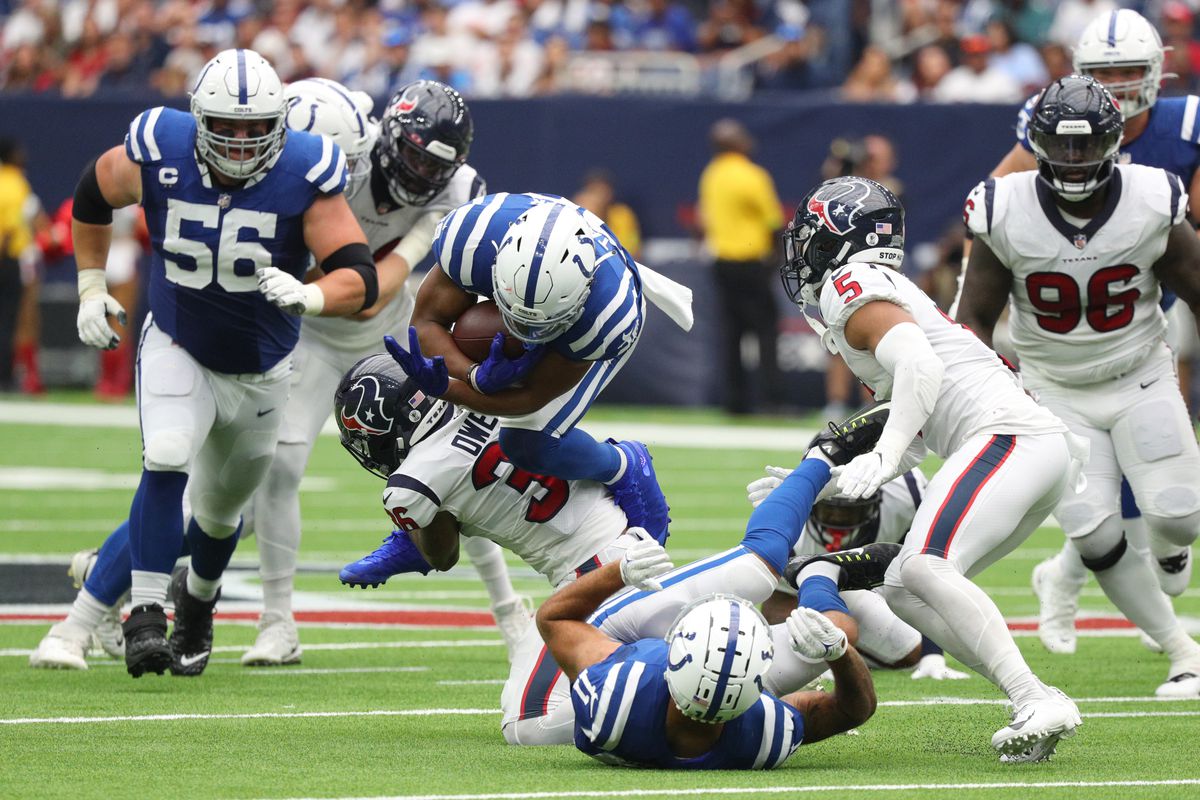 Jonathan Taylor #28 of the Indianapolis Colts is tackled by Jonathan Owens #36 of the Houston Texans during the second quarter at NRG Stadium on September 11, 2022 in Houston, Texas.