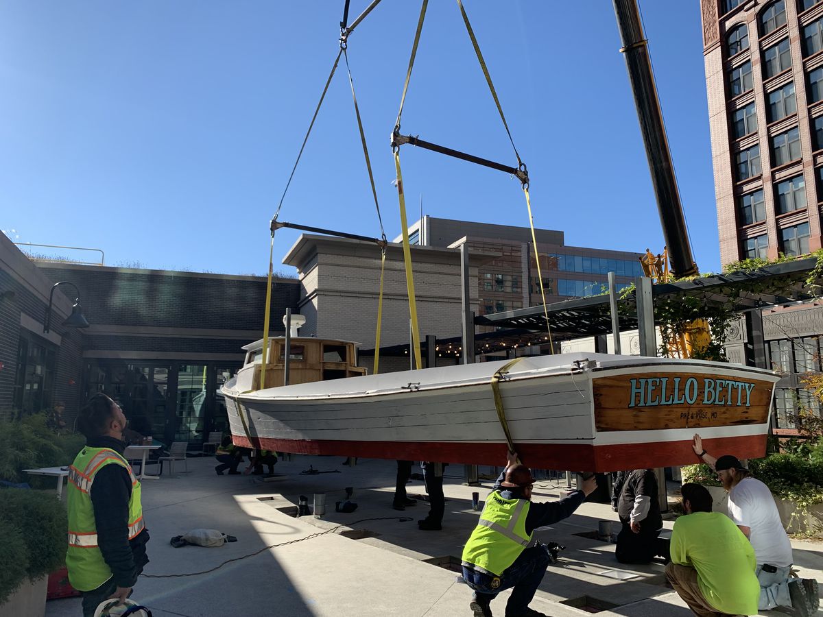 A 40-foot boat being moved onto the Hello Betty Bethesda  patio to be used as a bar
